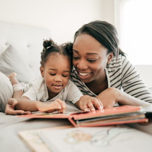 A mother reading to her daughter at Albany Hill Village in Albany, Georgia