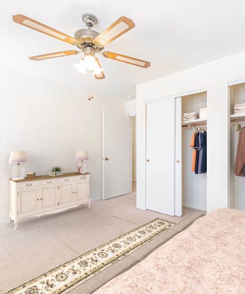 Bedroom with walk-in closets at Oaks On Bonhomme in University City, Missouri