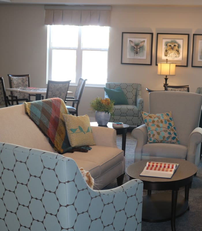 Community space with chairs and couches at The Sanctuary at Brooklyn Center in Brooklyn Center, Minnesota