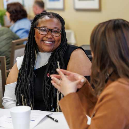 Team members collaborating during a community meeting at Pillar Properties in Seattle, Washington