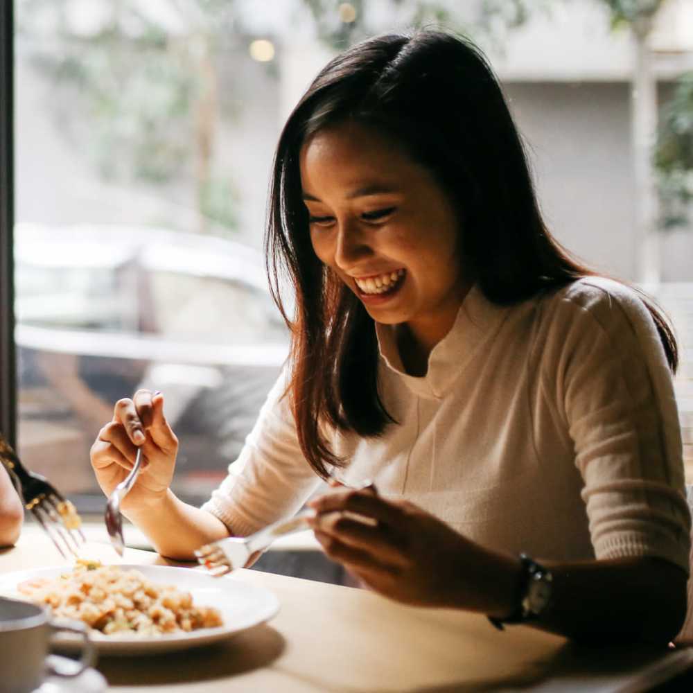 Resident having a delicious meal at herfavorite restaurant near Greenside in Charlotte, North Carolina