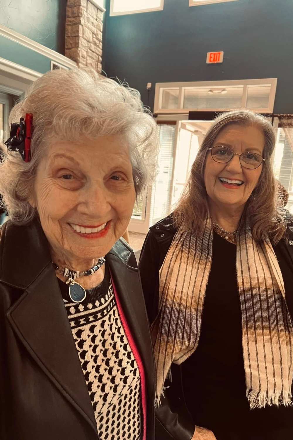Two residents smiling for a selfie at Isle at Cedar Ridge in Cedar Park, Texas, sharing a joyful moment.