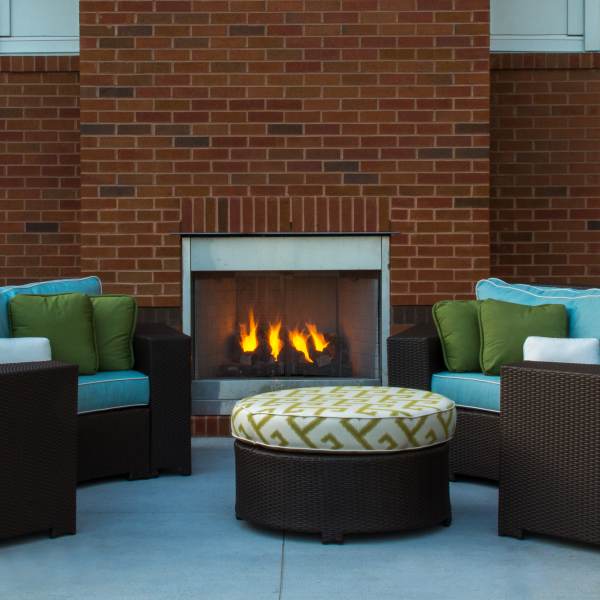 Resident patio with beautiful outdoor fireplace at Promenade Pointe, Norfolk, Virginia