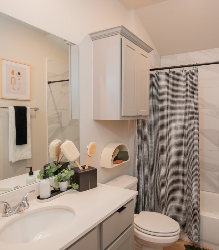 Model bathroom with tub and shower combo at Chisholm Pointe in Oklahoma City, Oklahoma