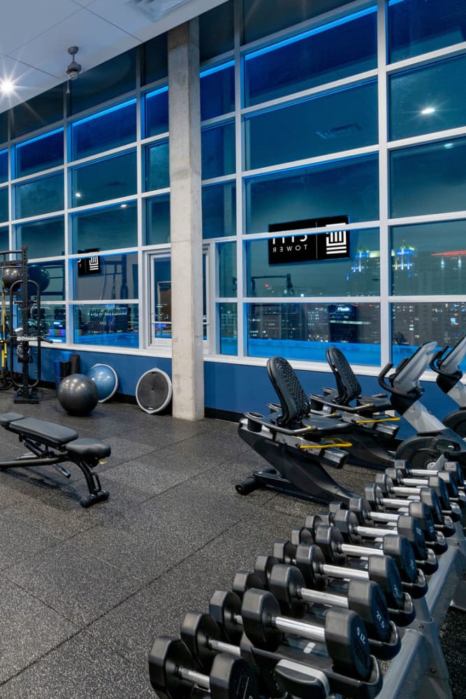Well-equipped fitness center with views of the city outside at CitiTower in Orlando, Florida