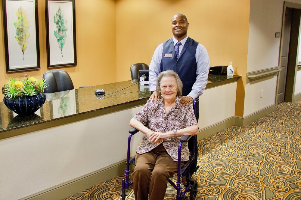 Staff member assisting a resident at an Integrated Senior Lifestyles community