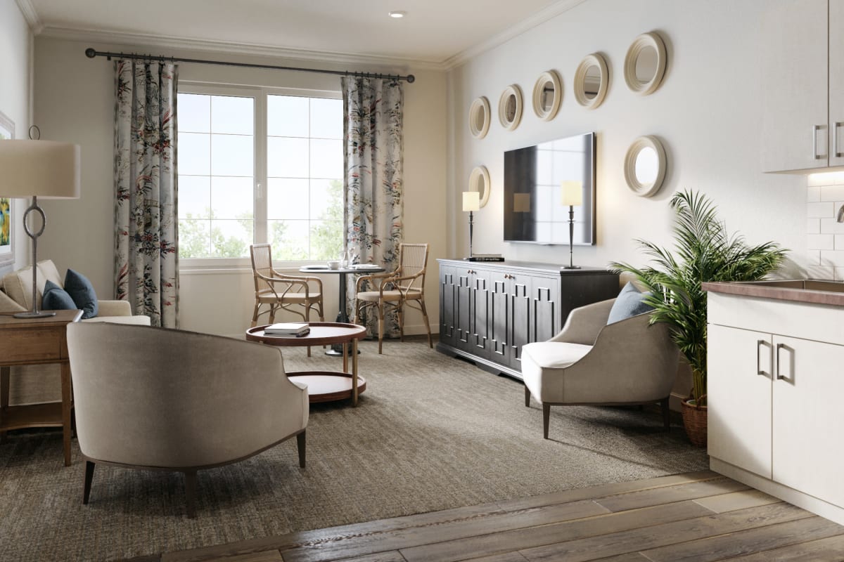 An apartment couch with flowers on the table at Magnolia Place in Bakersfield, California