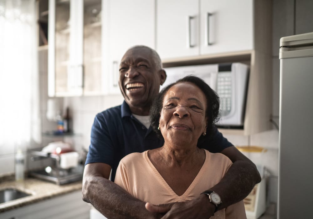 Resident couple hugging at Holden of Bellevue in Bellevue, Washington.