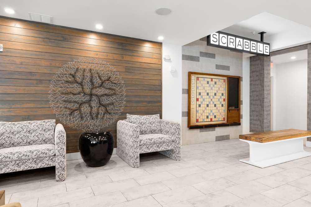 Resident common area with trendy lighting and leather seating at SoBA Apartments in Jacksonville, Florida