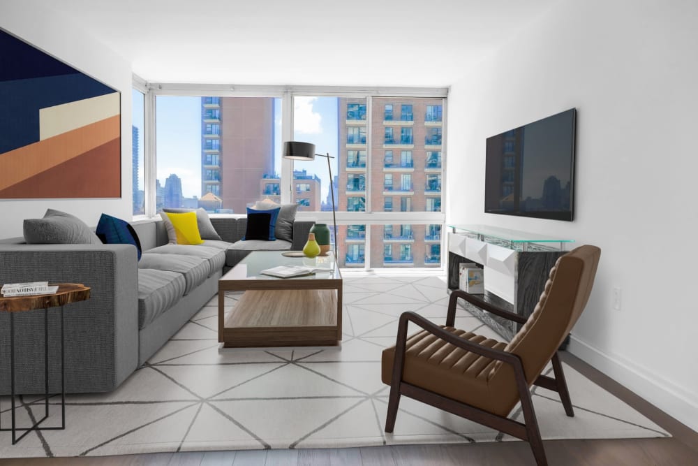 Spacious living room area with a large window at The Ventura in New York, New York