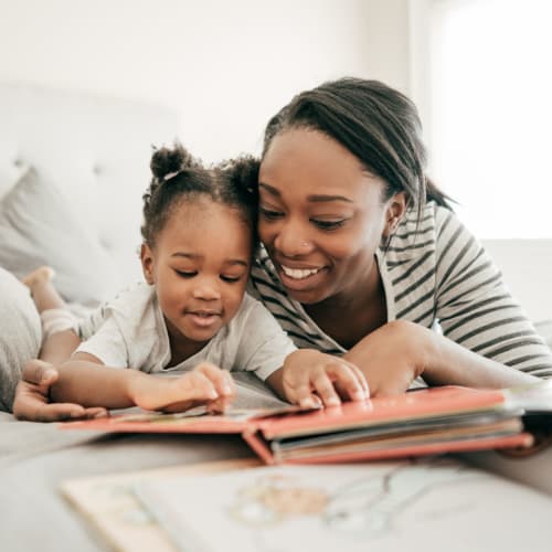 A mother reading to her daughter at Midway Manor in Virginia Beach, Virginia