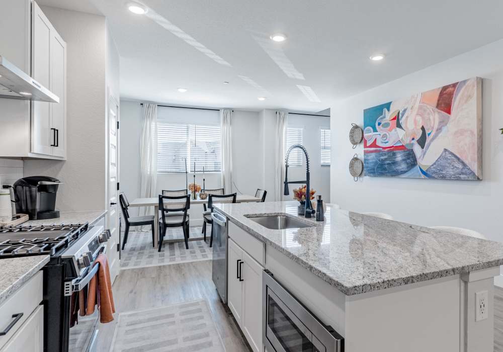 Kitchen featuring island, dining area & upgraded appliances 