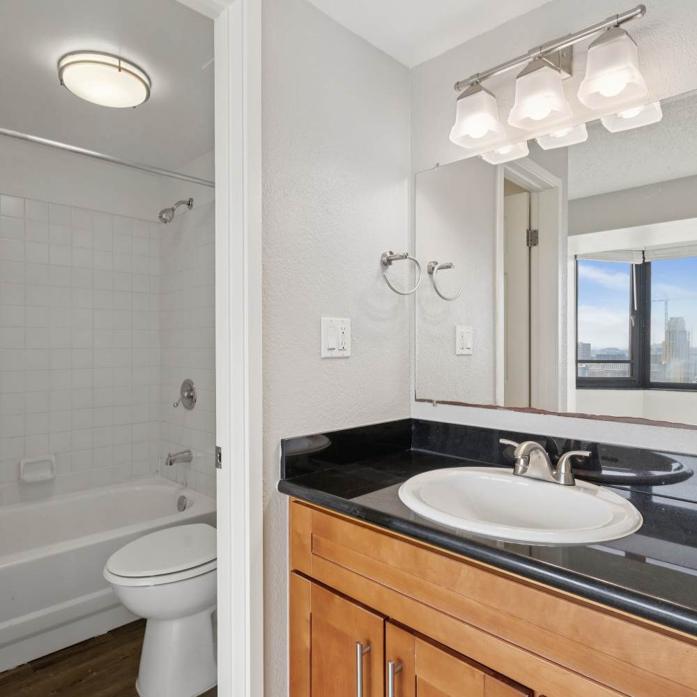 Bathroom with an oval tub and cabinet space in a standard apartment at Tower 737 Condominium Rentals in San Francisco, California