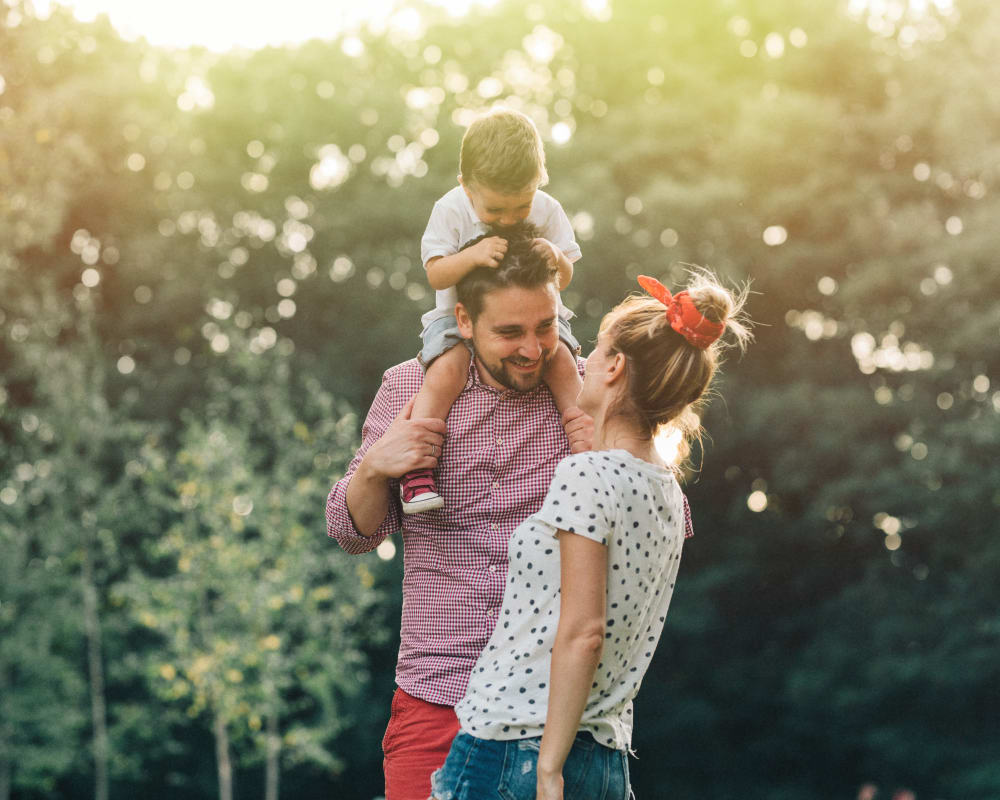 A family spending time together in a park-like area near Gateway Village in San Diego, California