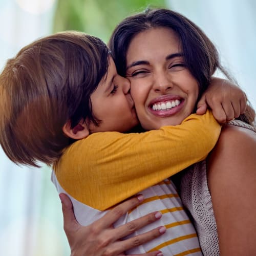 A child giving a resident a kiss on the cheek at San Onofre I in San Clemente, California