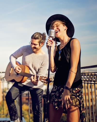 Musicians playing on a rooftop patio on a summer evening near at Solaire 7077 Woodmont in Bethesda, Maryland